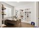 Home office featuring custom built-in shelving, a large window for natural light, and a modern desk at 27986 E Frost Pl, Aurora, CO 80016