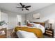 Cozy bedroom with a ceiling fan, a neutral color palette, and view into the walk-in closet at 6450 W 44Th Pl # B-3, Wheat Ridge, CO 80033