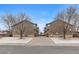 A symmetrical street view of townhomes with modern architecture and private garages at 6450 W 44Th Pl # B-3, Wheat Ridge, CO 80033