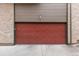 Garage door is paneled and painted red, situated under wood siding at 6450 W 44Th Pl # B-3, Wheat Ridge, CO 80033