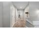 Upstairs hallway with neutral carpet, fresh paint, and doors to bedrooms or storage areas at 6450 W 44Th Pl # B-3, Wheat Ridge, CO 80033