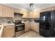 Efficient kitchen with stainless steel appliances, tile backsplash, and neutral cabinetry at 6450 W 44Th Pl # B-3, Wheat Ridge, CO 80033