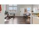 View of living room and dining space showing windows, and hardwood flooring at 6450 W 44Th Pl # B-3, Wheat Ridge, CO 80033