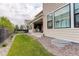 Manicured backyard features a stone patio, lush lawn, and modern outdoor furniture at 11142 Bright Sky St, Littleton, CO 80125