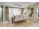 Contemporary dining room featuring stylish lighting fixture and large windows with sheer curtains at 11142 Bright Sky St, Littleton, CO 80125