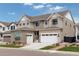 Beautiful two-story home featuring a manicured lawn, attached two car garage, and neutral colored siding at 11142 Bright Sky St, Littleton, CO 80125