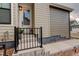 Charming front porch with black railing, stylish door, and decorative plants adding curb appeal at 11142 Bright Sky St, Littleton, CO 80125