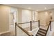 Upstairs hallway with carpet and wood railing, adjacent to bedrooms and bathrooms at 11142 Bright Sky St, Littleton, CO 80125