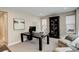 Bright home office with modern desk, comfortable seating, and stylish black display cabinet at 11142 Bright Sky St, Littleton, CO 80125