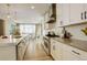 Bright, open kitchen with white cabinetry, stainless steel appliances, and eat-in dining area at 11142 Bright Sky St, Littleton, CO 80125