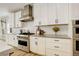 Contemporary kitchen with white cabinets, stainless steel appliances, and herringbone tile backsplash at 11142 Bright Sky St, Littleton, CO 80125