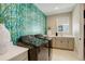 Modern laundry room with stylish wallpaper, a sink, and stainless-steel appliances at 11142 Bright Sky St, Littleton, CO 80125