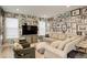 Eclectic living room with a large TV, comfortable seating, and unique, eye-catching wall decor at 11142 Bright Sky St, Littleton, CO 80125