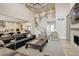 Spacious living room with a view of kitchen and staircase, complete with fireplace and a large sectional sofa at 11142 Bright Sky St, Littleton, CO 80125