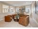 Bright and airy living room featuring four cozy brown armchairs and a stylish round coffee table at 11142 Bright Sky St, Littleton, CO 80125