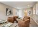 Bright living room with four brown armchairs, a round coffee table, and artistic wall decorations at 11142 Bright Sky St, Littleton, CO 80125