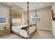 Spacious main bedroom with four-poster bed, natural light, and elegant decor at 11142 Bright Sky St, Littleton, CO 80125