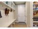 Convenient mudroom area with built-in bench, storage shelves, and pantry access at 11142 Bright Sky St, Littleton, CO 80125