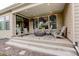 Covered patio with comfortable seating around a modern fire pit feature at 11142 Bright Sky St, Littleton, CO 80125