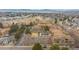 Expansive aerial view of a residential community featuring tennis courts, a pool, and mountain views at 3325 S Ammons St # 4-206, Lakewood, CO 80227