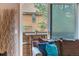 View from the living room slider shows cozy balcony with outdoor seating at 3325 S Ammons St # 4-206, Lakewood, CO 80227