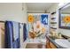 Bright bathroom with a floral shower curtain, wood-look floors, and dark granite vanity at 3325 S Ammons St # 4-206, Lakewood, CO 80227