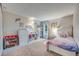 Bright bedroom with shelving, plush toys, and floral decor at 3325 S Ammons St # 4-206, Lakewood, CO 80227