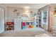 Bright bedroom with shelving, plush toys, and natural light at 3325 S Ammons St # 4-206, Lakewood, CO 80227