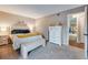Bedroom featuring plush carpeting, updated furnishings, and access to the bathroom at 3325 S Ammons St # 4-206, Lakewood, CO 80227