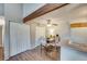 Open dining area featuring modern lighting, hardwood floors, and adjacent kitchen access at 3325 S Ammons St # 4-206, Lakewood, CO 80227