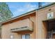 Apartment building featuring a balcony, wood facade, and stairs leading to upper units at 3325 S Ammons St # 4-206, Lakewood, CO 80227