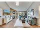 Inviting living room with stone fireplace, plush sectional, and sliding glass doors to a balcony at 3325 S Ammons St # 4-206, Lakewood, CO 80227