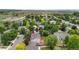 Aerial view of home in a quiet neighborhood featuring mature trees, fenced backyard, and proximity to schools and parks at 7171 Canyon Way, Frederick, CO 80504