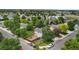 Aerial view of home with fenced backyard, mature trees and lush green lawn in a well-maintained neighborhood at 7171 Canyon Way, Frederick, CO 80504