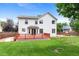 Expansive backyard featuring a red deck, lawn, and lush landscaping at 7171 Canyon Way, Frederick, CO 80504