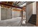 Unfinished basement with exposed beams and stairs leading to the upper level at 7171 Canyon Way, Frederick, CO 80504