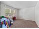 Bright bedroom with neutral carpet and a large window providing ample natural light at 7171 Canyon Way, Frederick, CO 80504
