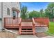 Cozy wooden deck with steps down to a stone garden and green backyard at 7171 Canyon Way, Frederick, CO 80504