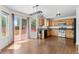 Bright kitchen with wooden cabinetry, stainless steel appliances, and access to an outdoor deck at 7171 Canyon Way, Frederick, CO 80504