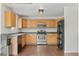 Open kitchen featuring stainless steel appliances, light wood cabinets and hardwood flooring at 7171 Canyon Way, Frederick, CO 80504