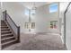 Spacious living room with soaring ceilings, large windows, and staircase at 7171 Canyon Way, Frederick, CO 80504