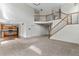 Open-concept living room with soaring ceilings, staircase, and seamless flow into the kitchen area at 7171 Canyon Way, Frederick, CO 80504
