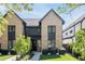 Charming two-story home featuring a brick exterior, black trim, and a well-manicured front yard at 3934 Kalamath St, Denver, CO 80211