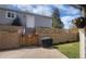 Charming backyard featuring a brick patio, retaining wall with colorful flowers, and a well-maintained lawn at 2525 S Pennsylvania St, Denver, CO 80210
