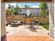 Backyard with a paver patio, retaining wall with flowers, dining furniture, sofa set, and a grill at 2525 S Pennsylvania St, Denver, CO 80210