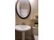 Cozy bathroom with a pedestal sink, oval mirror, and decorative accents at 2525 S Pennsylvania St, Denver, CO 80210