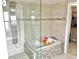 Bathroom featuring a large glass enclosed shower with a soaking tub and modern fixtures at 2525 S Pennsylvania St, Denver, CO 80210