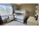 Bright bedroom with a white bunk bed, white nightstand, white dresser, a rug and large window at 2525 S Pennsylvania St, Denver, CO 80210