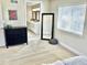 Bright bedroom featuring a dresser, a decorative mirror and an ensuite bathroom at 2525 S Pennsylvania St, Denver, CO 80210