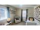 Bedroom with natural light, a gray accent wall, shelving and comfortable seating at 2525 S Pennsylvania St, Denver, CO 80210